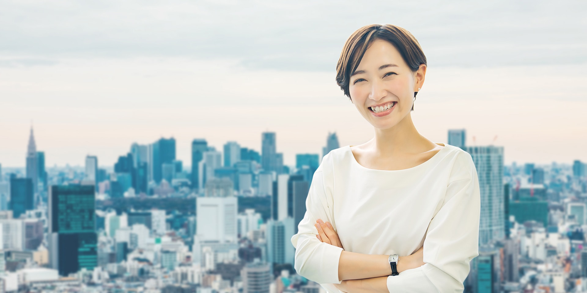 Professional woman standing with city skyline in the background